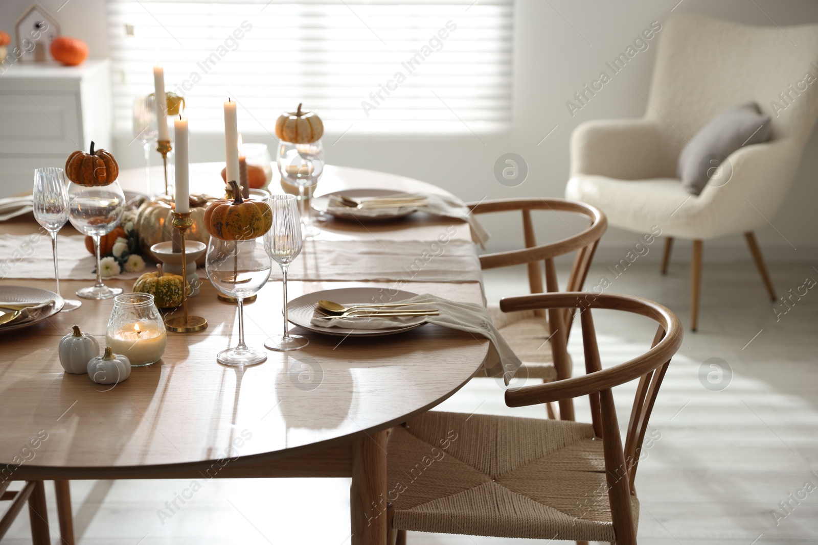 Photo of Stylish dining room with beautiful table setting and autumn decor