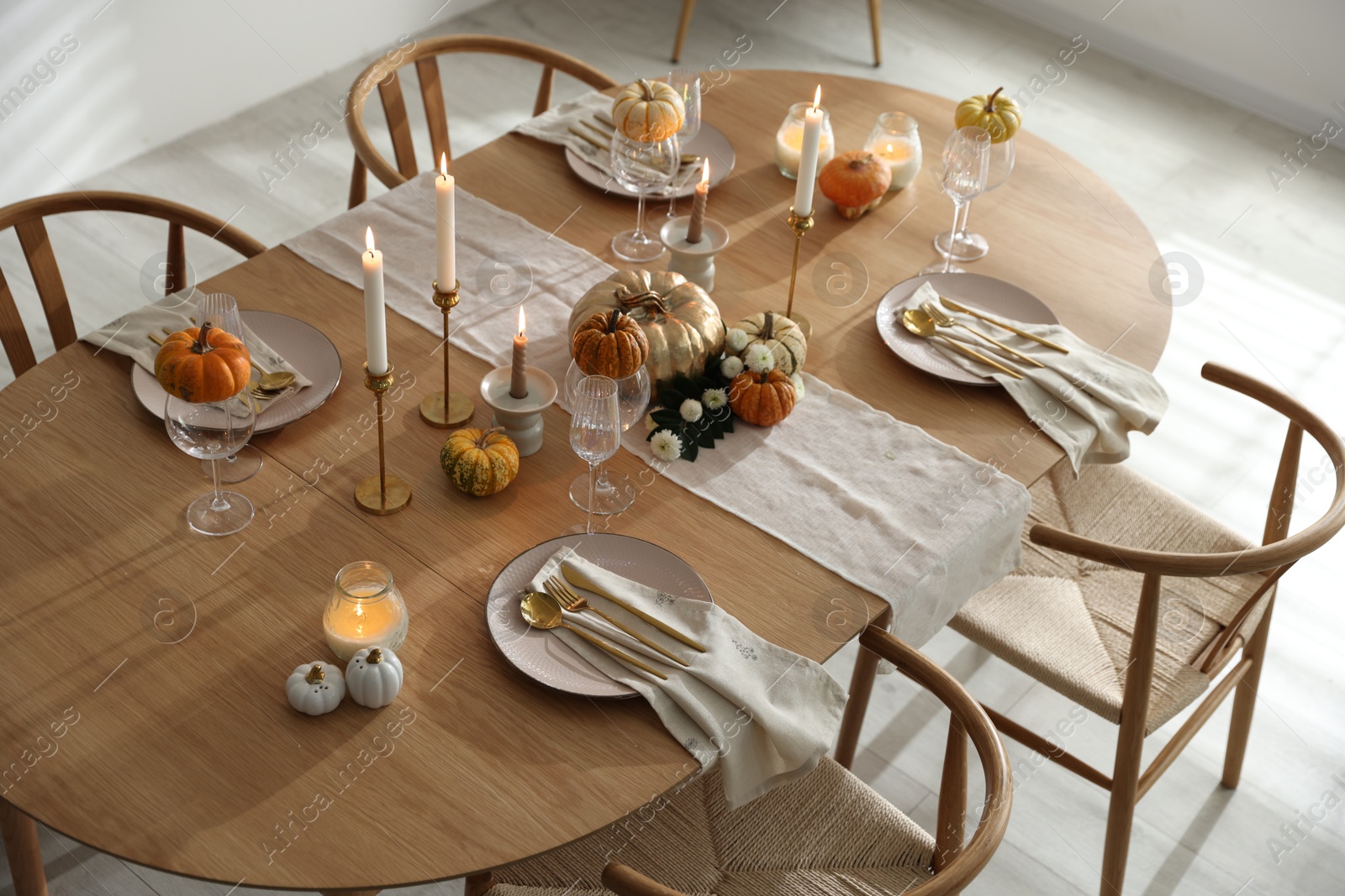 Photo of Stylish dining room with beautiful table setting and autumn decor