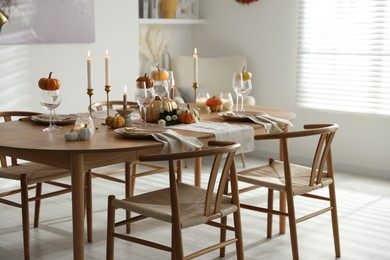 Photo of Stylish dining room with beautiful table setting and autumn decor