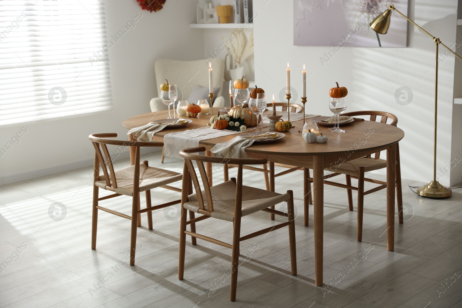 Photo of Stylish dining room with beautiful table setting and autumn decor