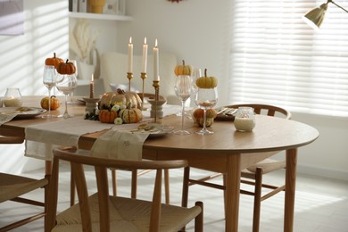 Stylish dining room with beautiful table setting and autumn decor