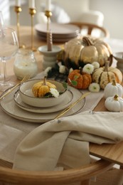 Stylish table setting with beautiful dishware and autumn decor in dining room