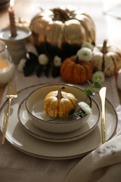 Stylish table setting with beautiful dishware and autumn decor in dining room