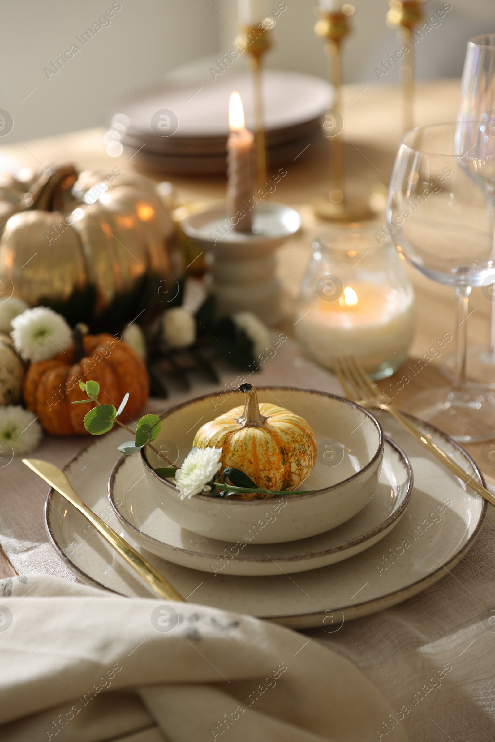 Photo of Stylish table setting with beautiful dishware and autumn decor in dining room