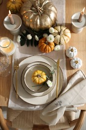 Stylish table setting with beautiful dishware and autumn decor in dining room, top view