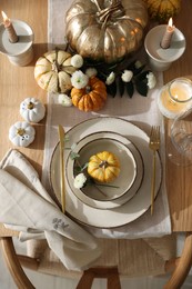 Stylish table setting with beautiful dishware and autumn decor in dining room, top view