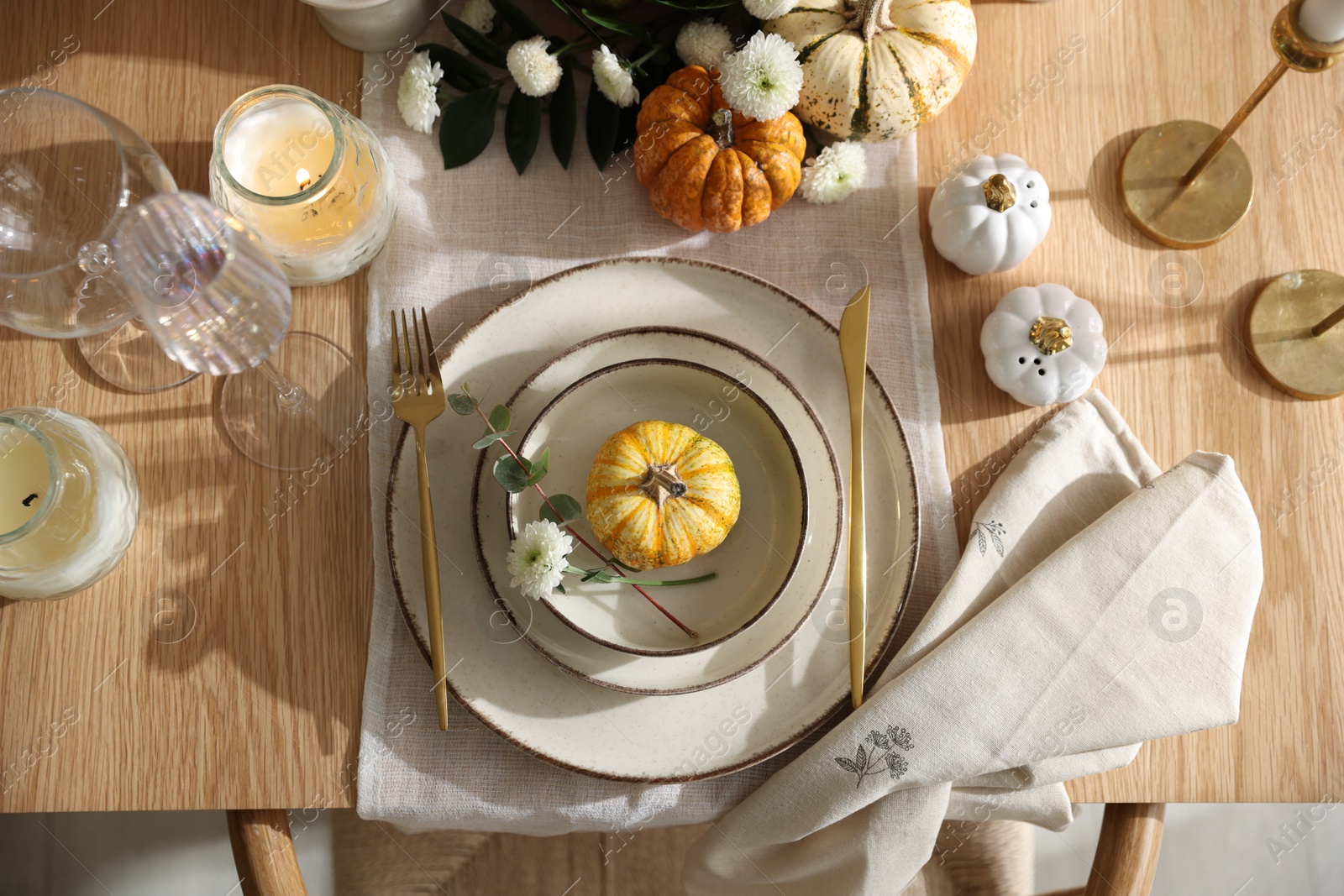 Photo of Stylish table setting with beautiful dishware and autumn decor in dining room, top view