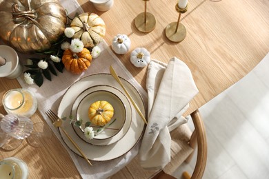 Stylish table setting with beautiful dishware and autumn decor in dining room, top view