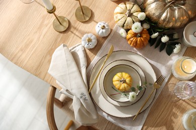 Stylish table setting with beautiful dishware and autumn decor in dining room, top view