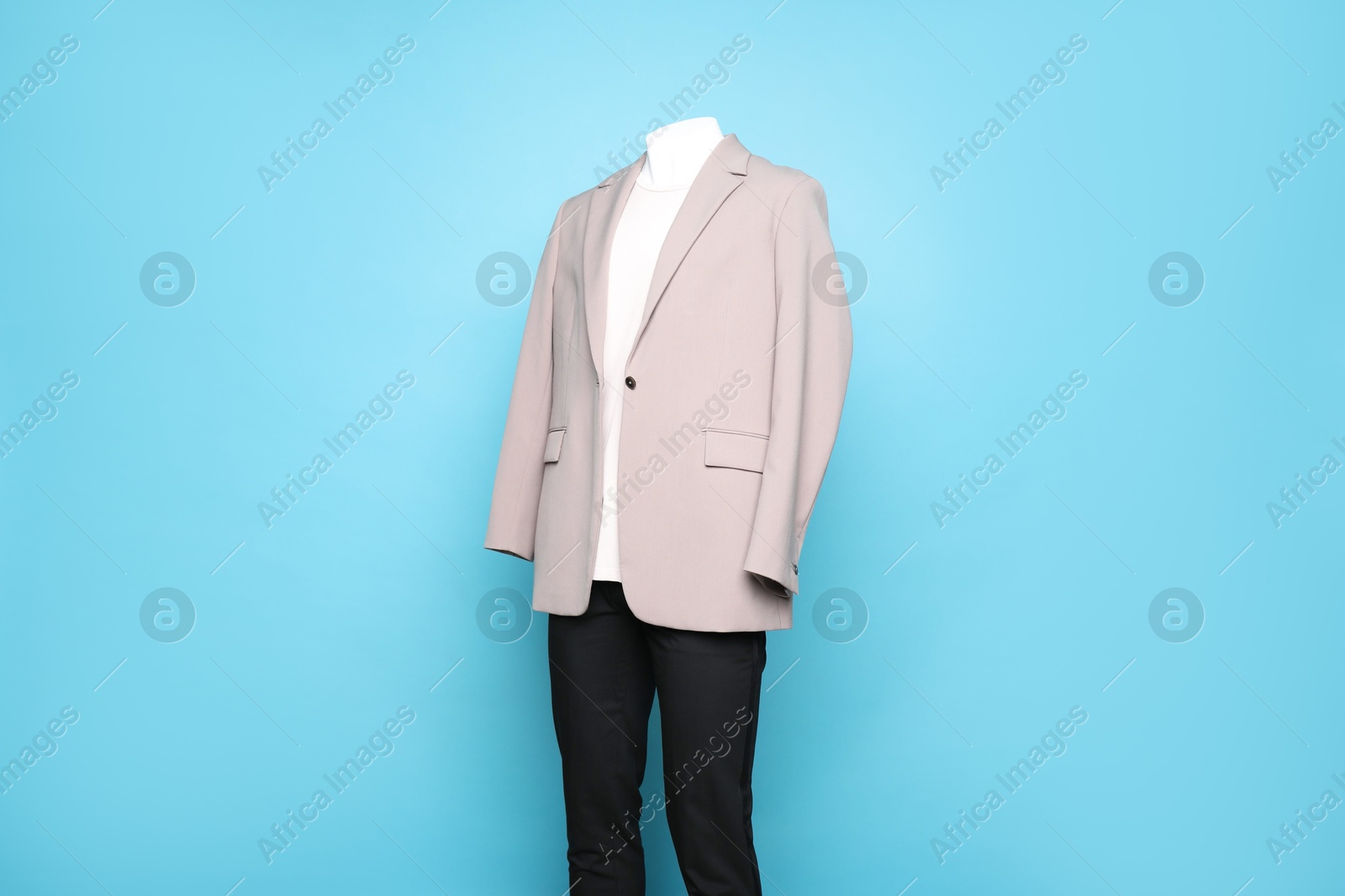 Photo of Male mannequin with stylish outfit on light blue background