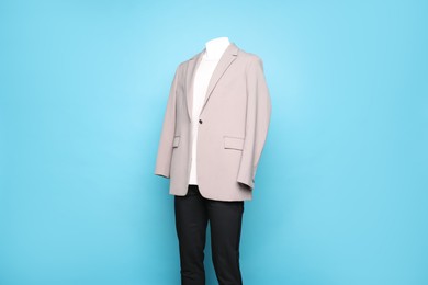 Photo of Male mannequin with stylish outfit on light blue background