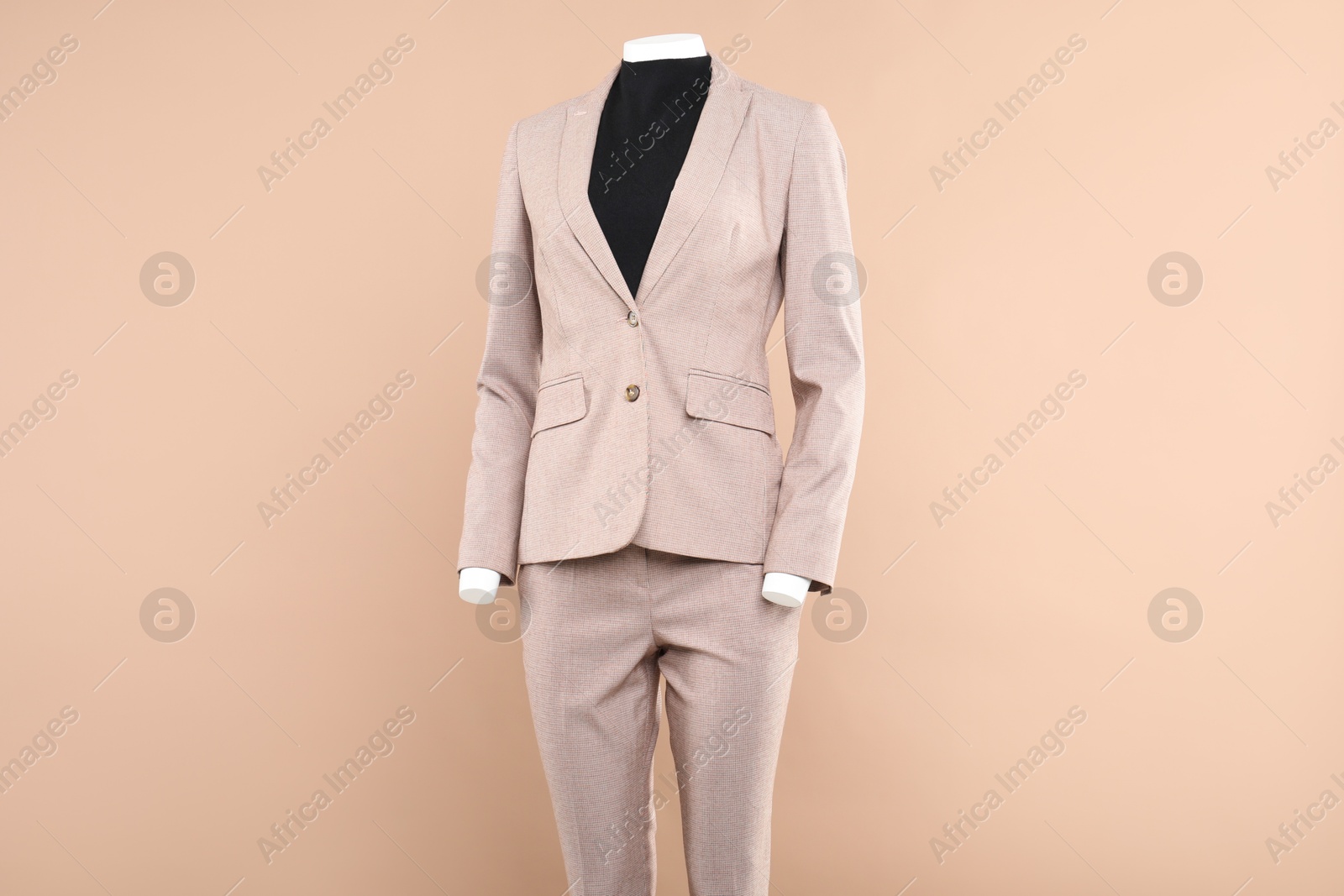 Photo of Female mannequin with stylish outfit on beige background