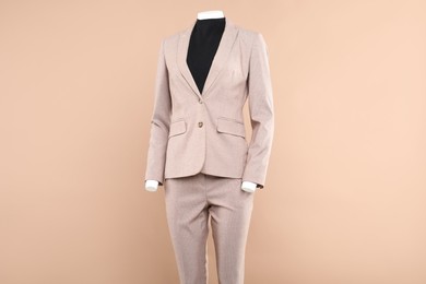 Photo of Female mannequin with stylish outfit on beige background