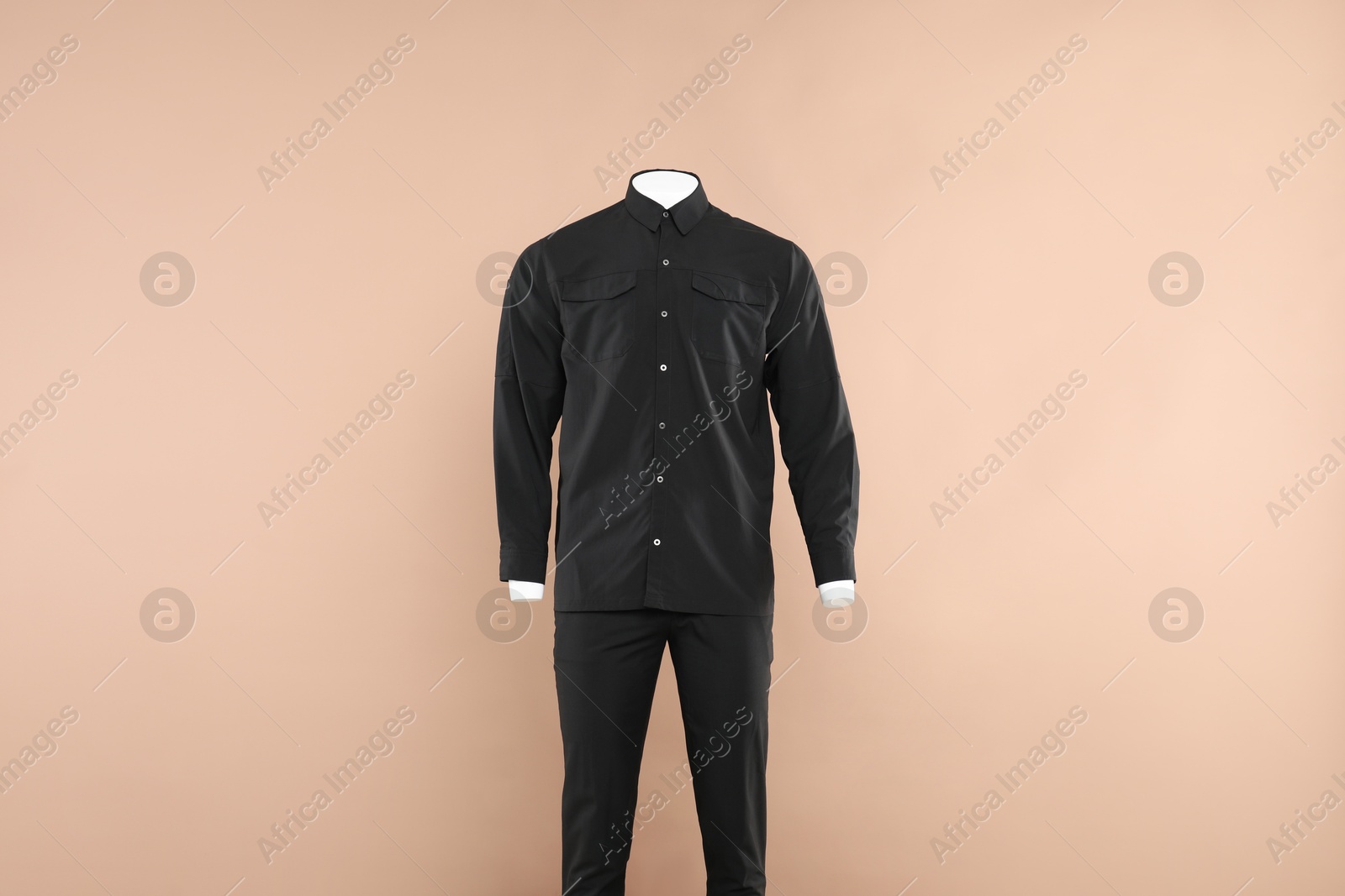 Photo of Male mannequin with stylish outfit on beige background