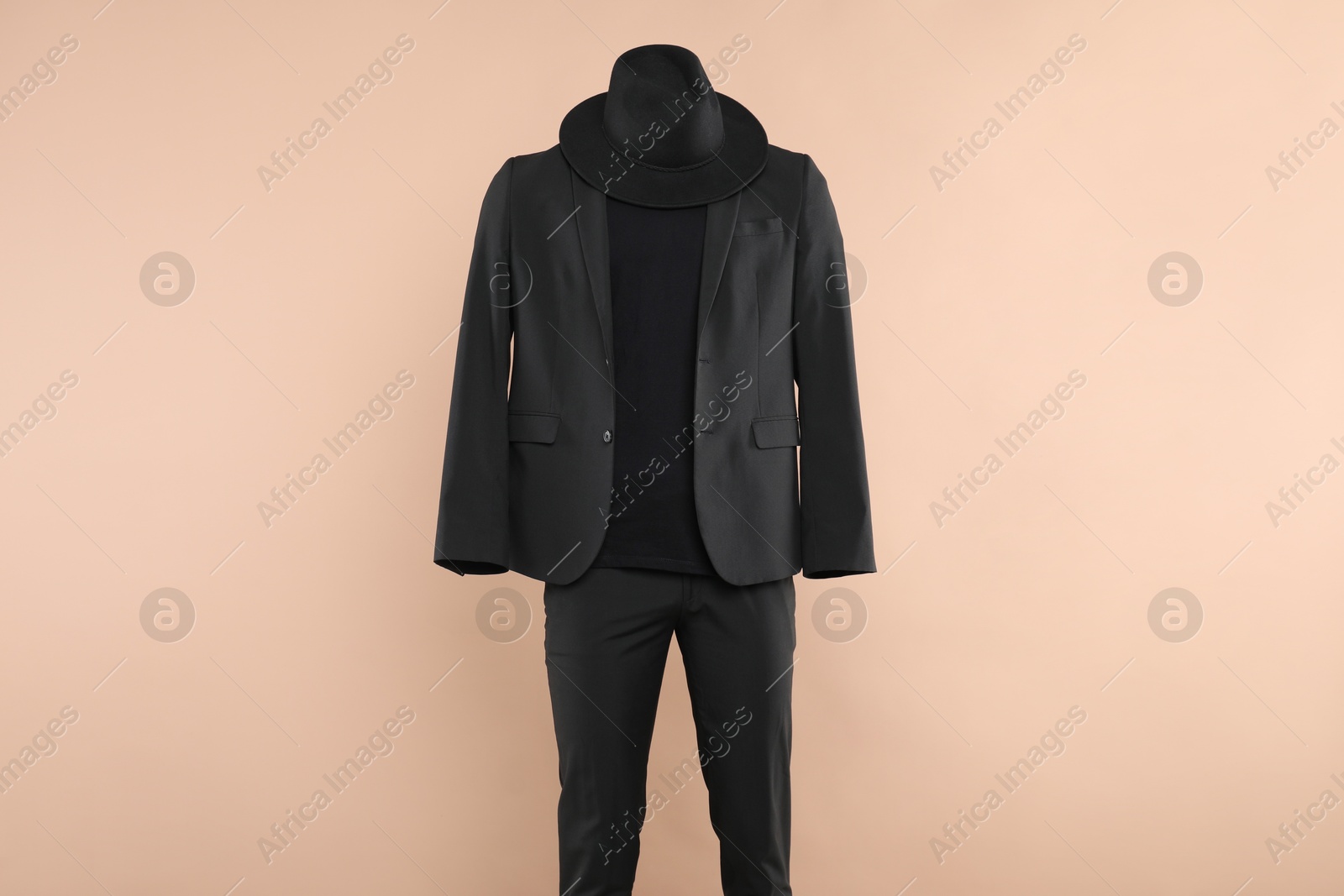 Photo of Male mannequin with stylish outfit on beige background