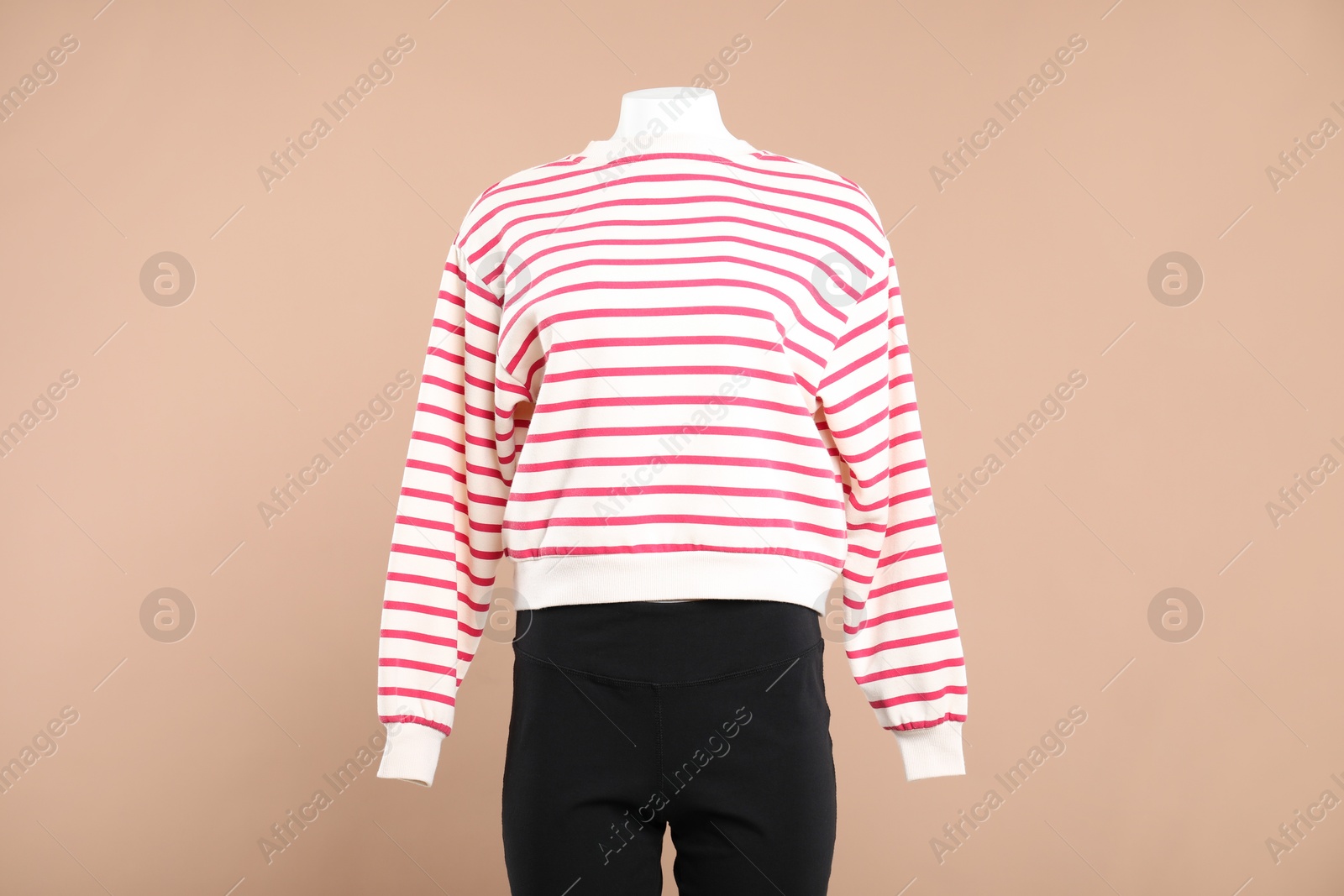 Photo of Female mannequin with stylish outfit on beige background