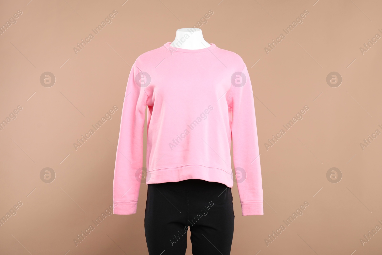 Photo of Female mannequin with stylish outfit on beige background