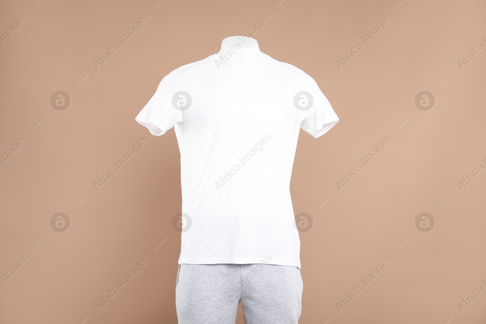 Photo of Male mannequin with stylish sportswear on beige background