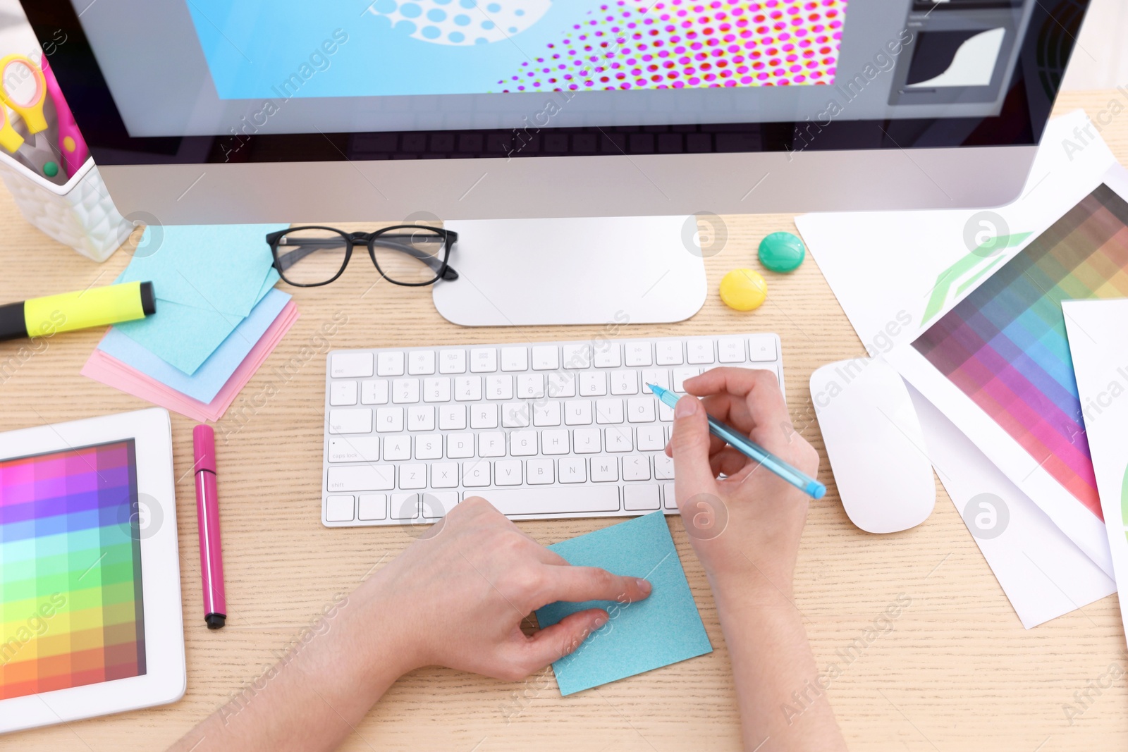 Photo of Designer working at wooden table indoors, top view