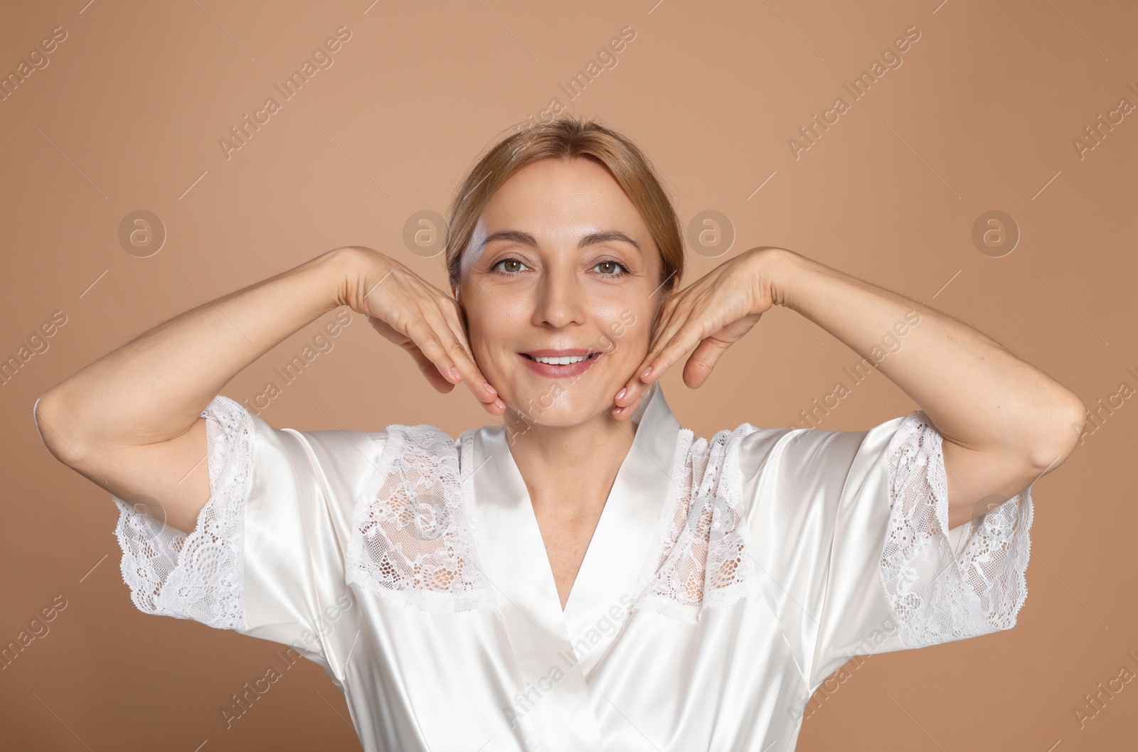 Photo of Portrait of smiling woman with healthy skin on beige background