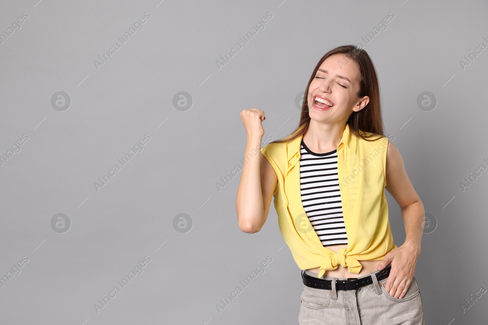 Photo of Happy winner on gray background, space for text