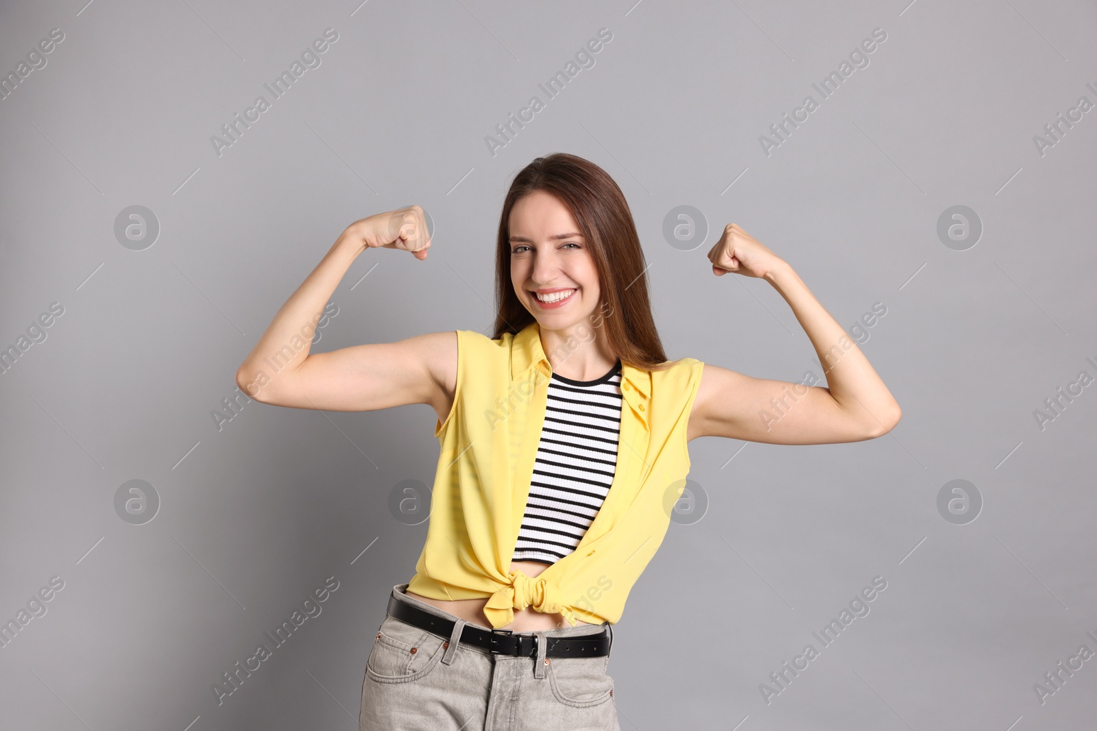 Photo of Portrait of happy winner on gray background