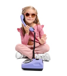 Photo of Cute little girl with telephone on white background