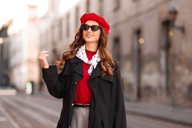 Photo of Charming young woman in stylish outfit on city street. Autumn season