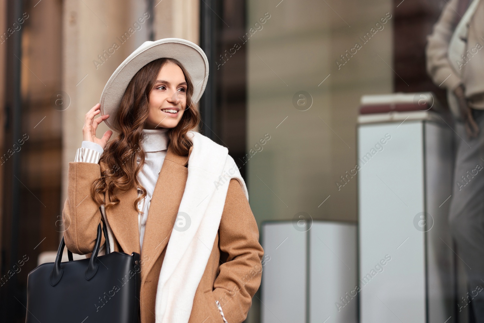 Photo of Young woman in beautiful outfit on city street, space for text. Autumn style