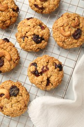 Delicious oatmeal cookies with raisins and nuts on white marble table, top view