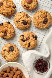 Photo of Delicious oatmeal cookies with raisins and nuts on white marble table, flat lay