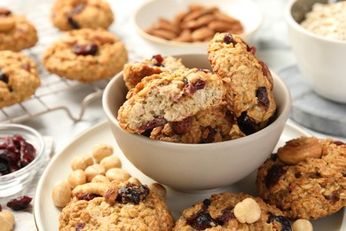 Photo of Delicious oatmeal cookies with raisins and nuts on table, closeup