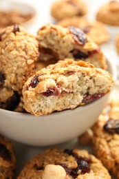 Photo of Delicious oatmeal cookies with raisins and nuts on table, closeup