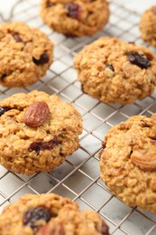 Delicious oatmeal cookies with raisins and nuts on white marble table, closeup