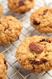 Photo of Delicious oatmeal cookies with raisins and nuts on table, closeup