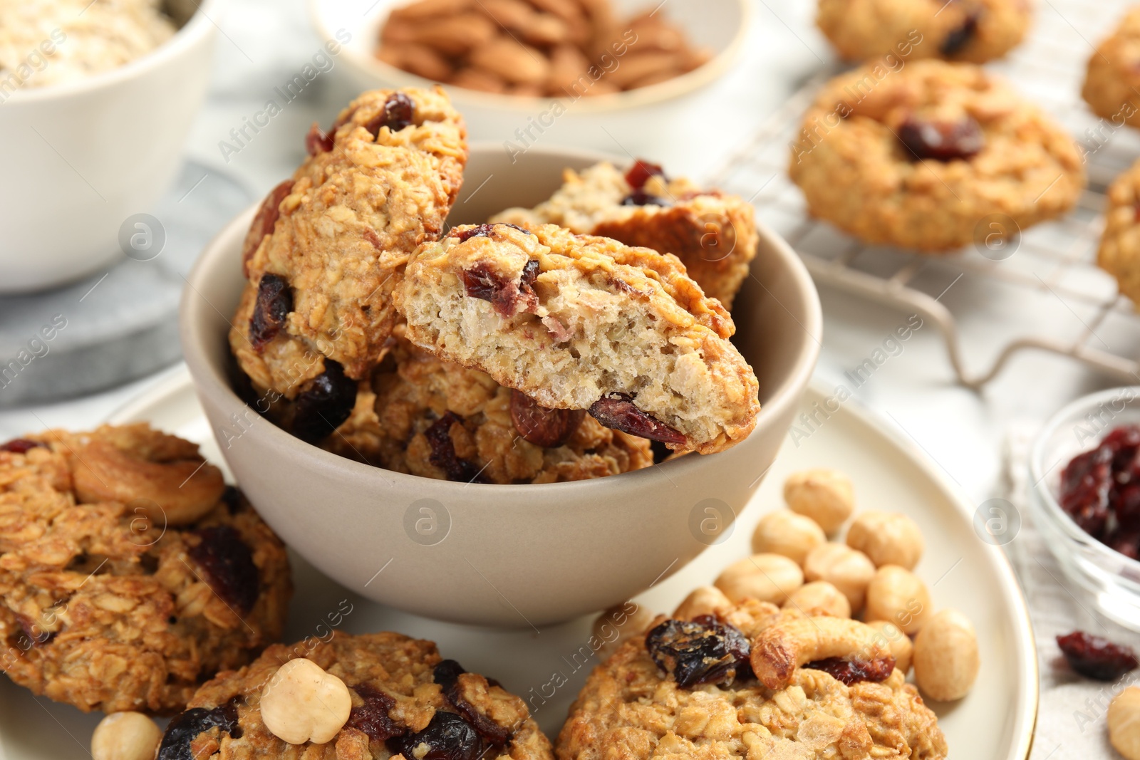 Photo of Delicious oatmeal cookies with raisins and nuts on table, closeup