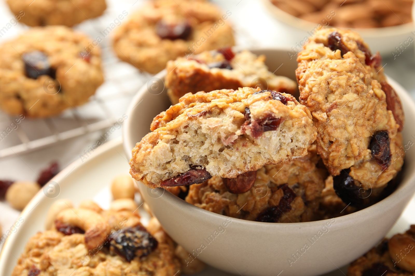 Photo of Delicious oatmeal cookies with raisins and nuts on table, closeup