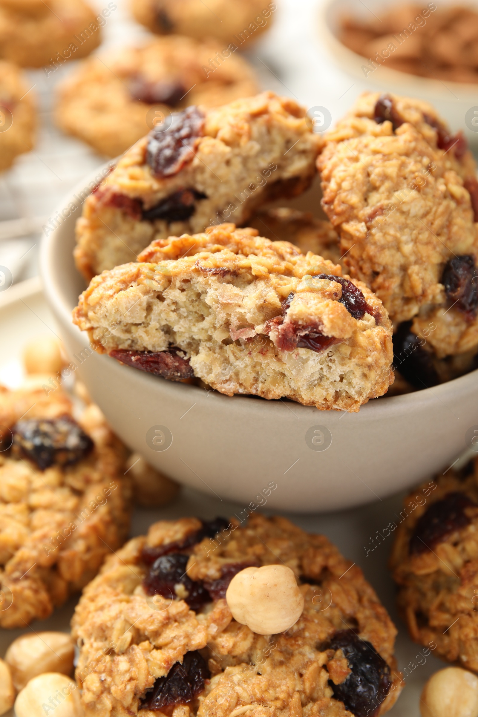 Photo of Delicious oatmeal cookies with raisins and nuts on table, closeup