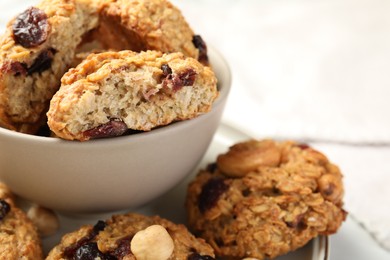 Photo of Delicious oatmeal cookies with raisins and nuts on table, closeup