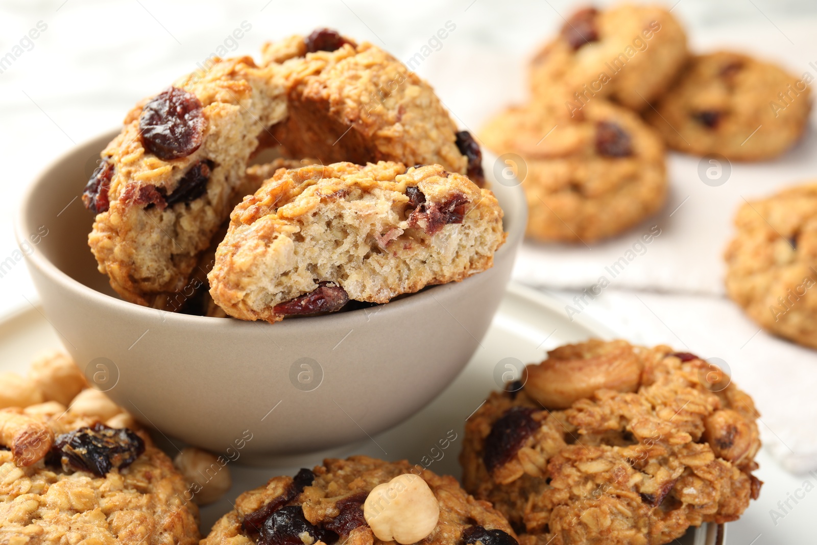 Photo of Delicious oatmeal cookies with raisins and nuts on table, closeup