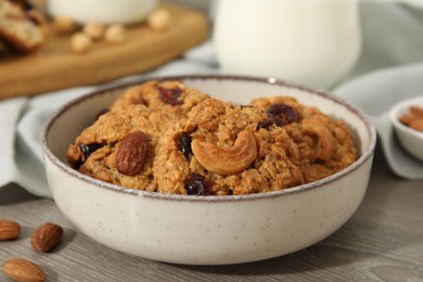 Delicious oatmeal cookies with raisins and nuts on wooden table, closeup