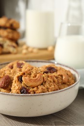 Delicious oatmeal cookies with raisins and nuts on wooden table, closeup