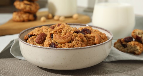 Photo of Delicious oatmeal cookies with raisins and nuts on wooden table, closeup