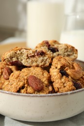 Delicious oatmeal cookies with raisins and nuts on table, closeup