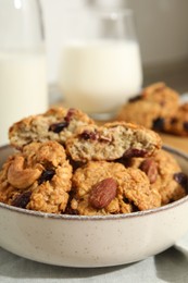 Photo of Delicious oatmeal cookies with raisins and nuts on table, closeup