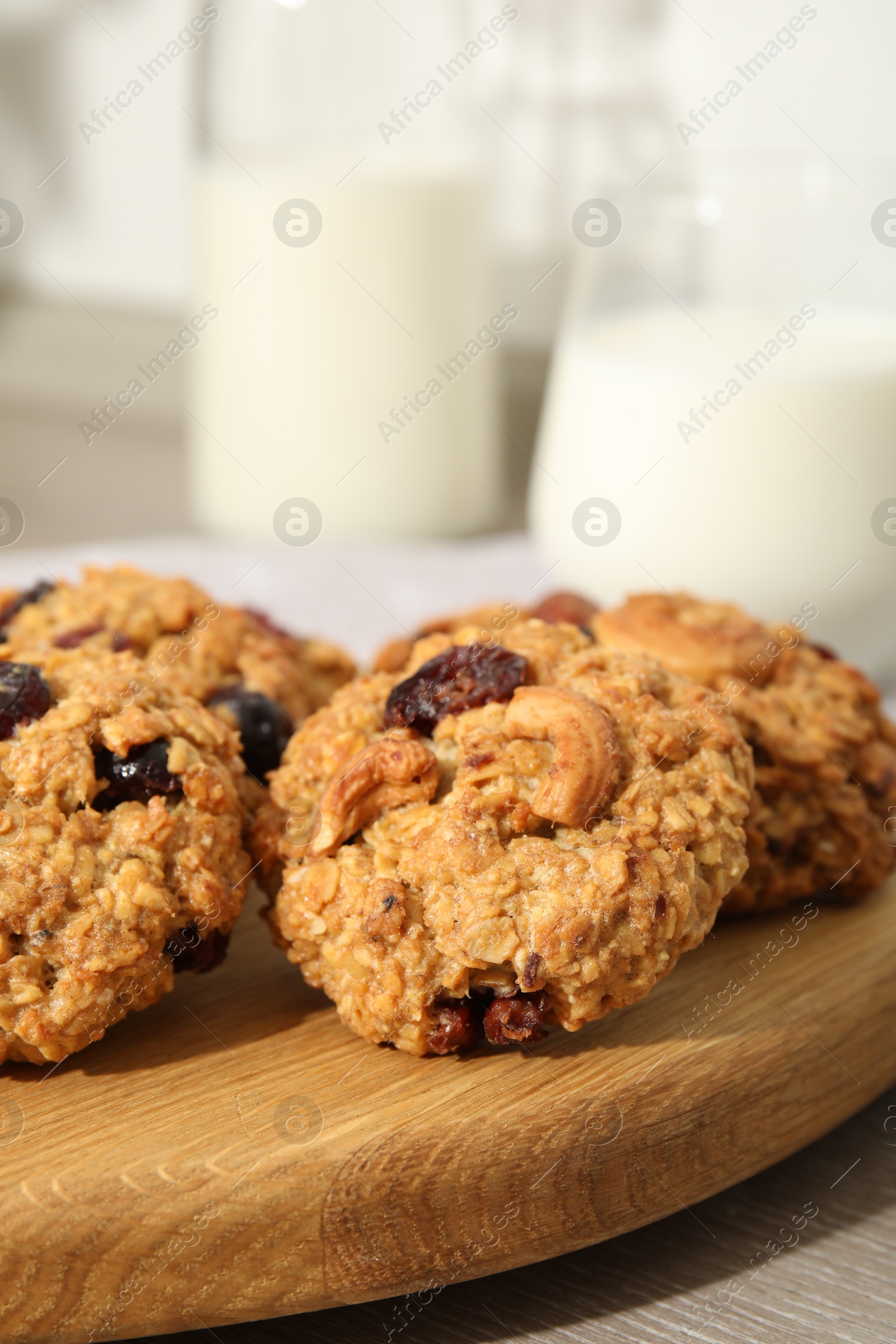 Photo of Delicious oatmeal cookies with raisins and nuts on table, closeup