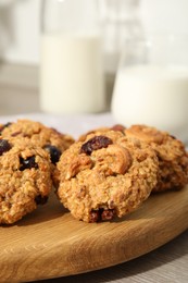 Delicious oatmeal cookies with raisins and nuts on table, closeup