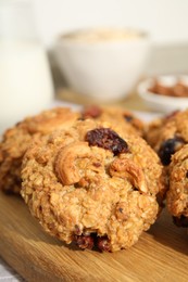 Delicious oatmeal cookies with raisins and nuts on table, closeup