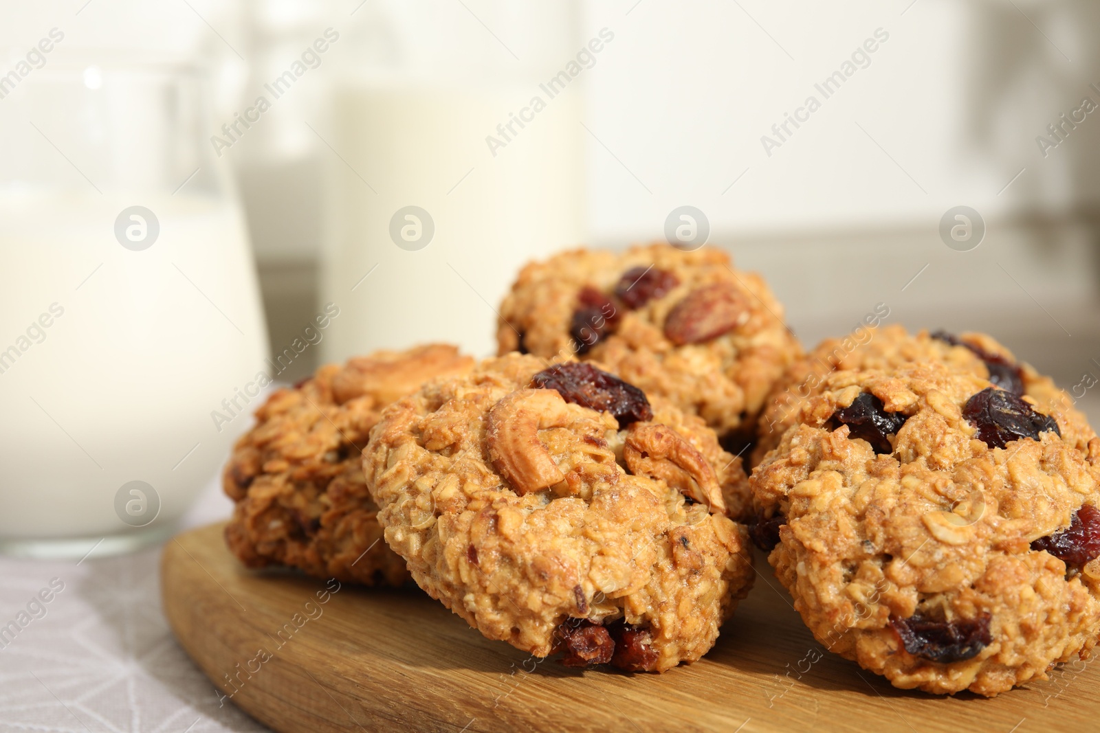 Photo of Delicious oatmeal cookies with raisins and nuts on table, closeup