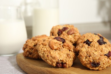 Delicious oatmeal cookies with raisins and nuts on table, closeup